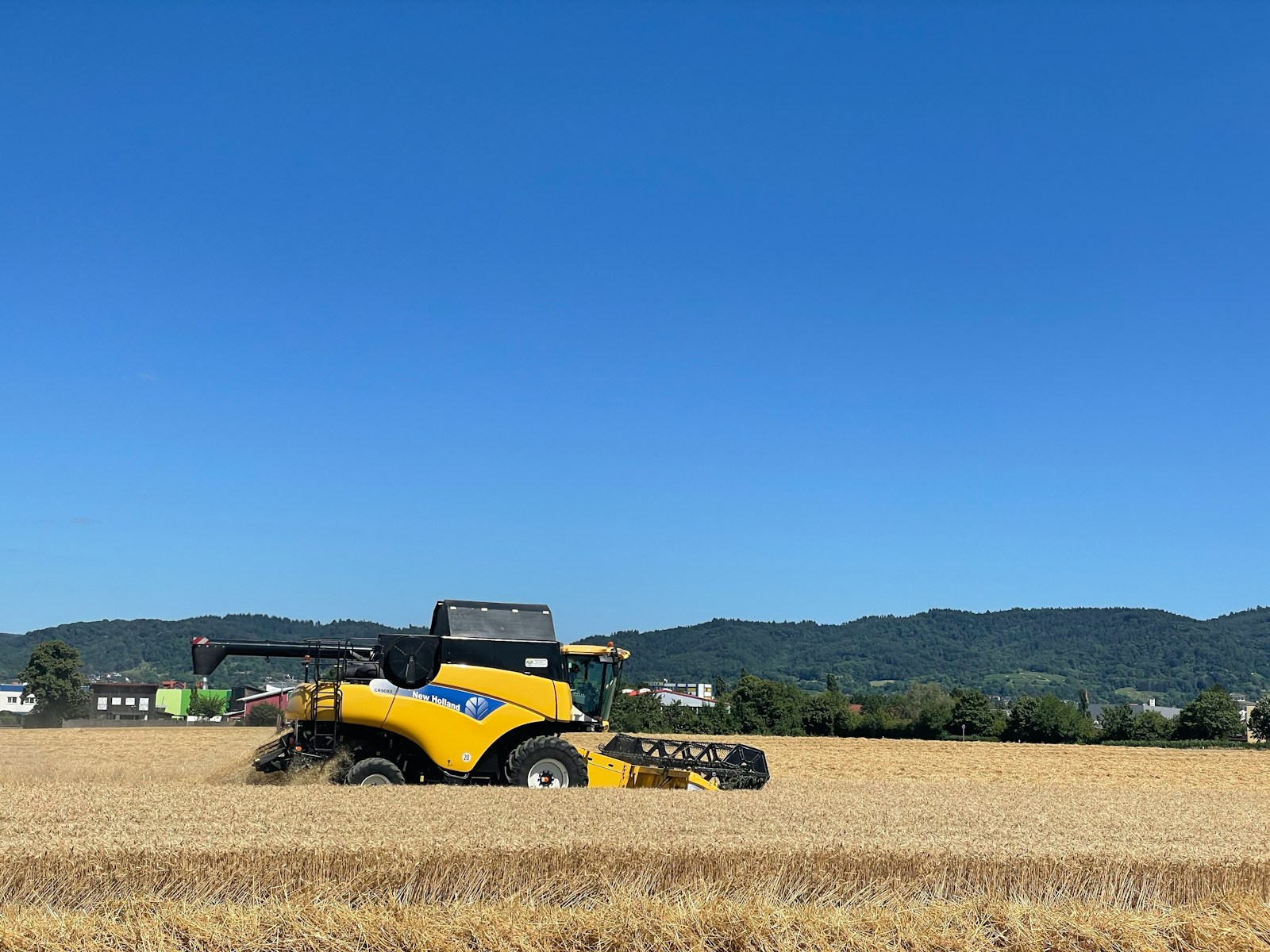 a yellow tractor in a field, farm vehicle insurance