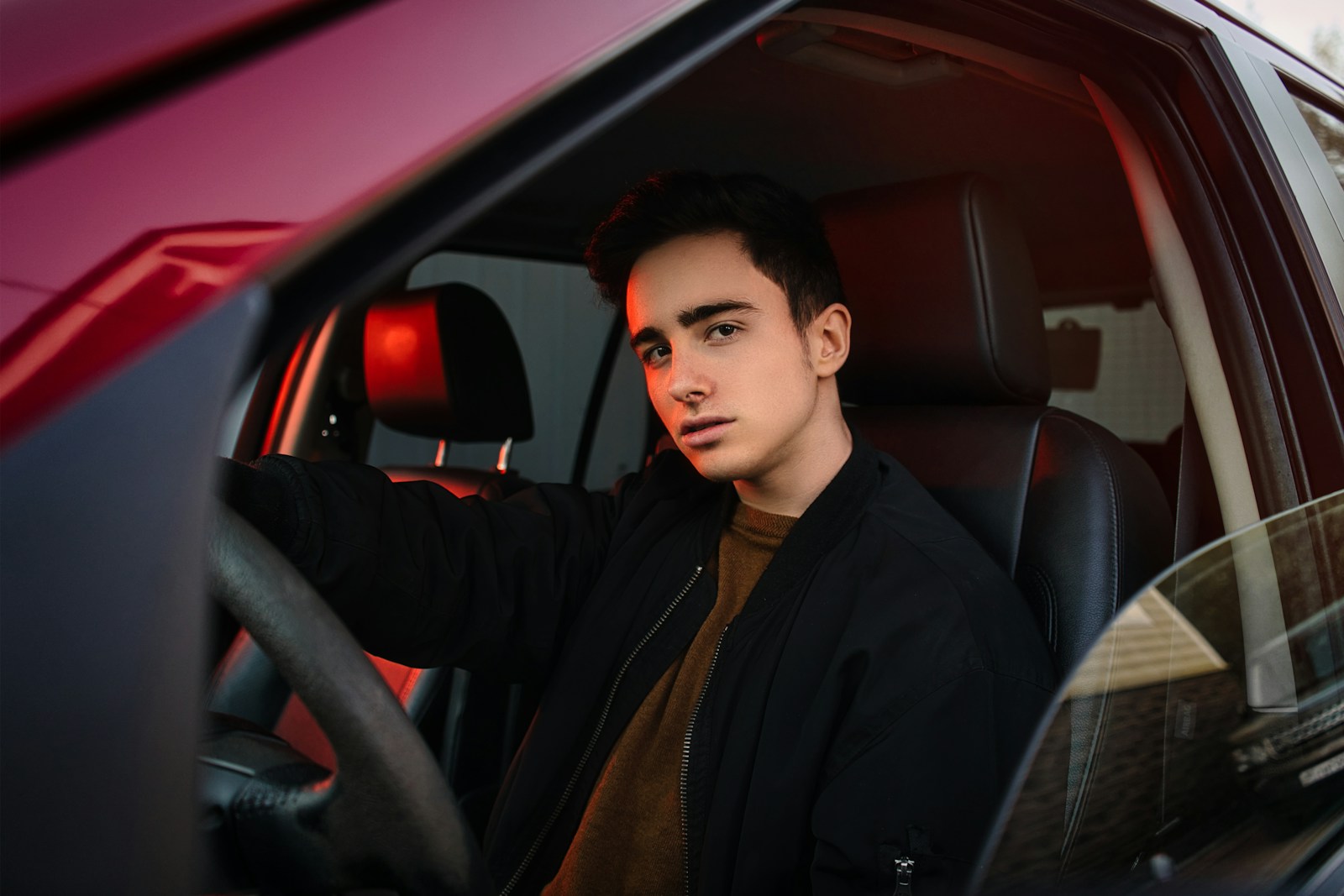 man in black suit jacket sitting on car seat, auto, driver